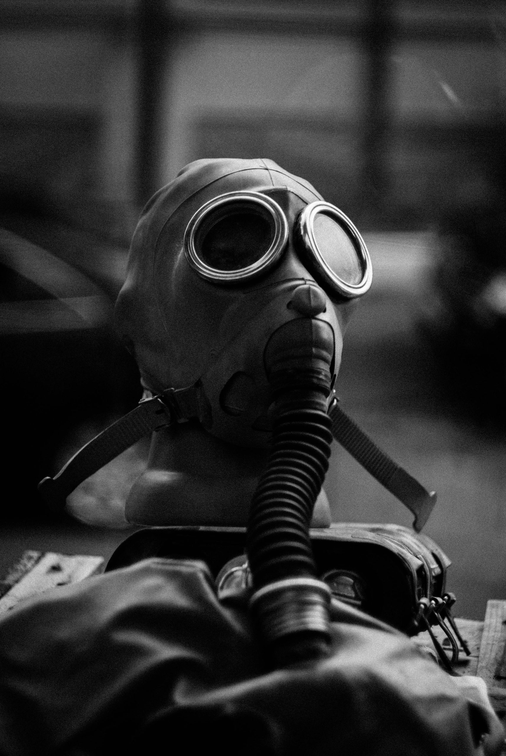 Grayscale image showcasing a vintage gas mask on display, emphasizing safety and protection themes.
