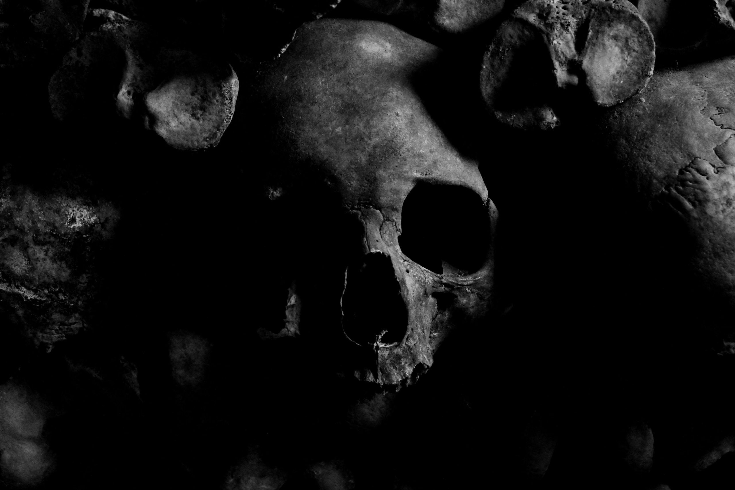 Dark eerie skull image with a moody atmosphere from the Paris Catacombs.