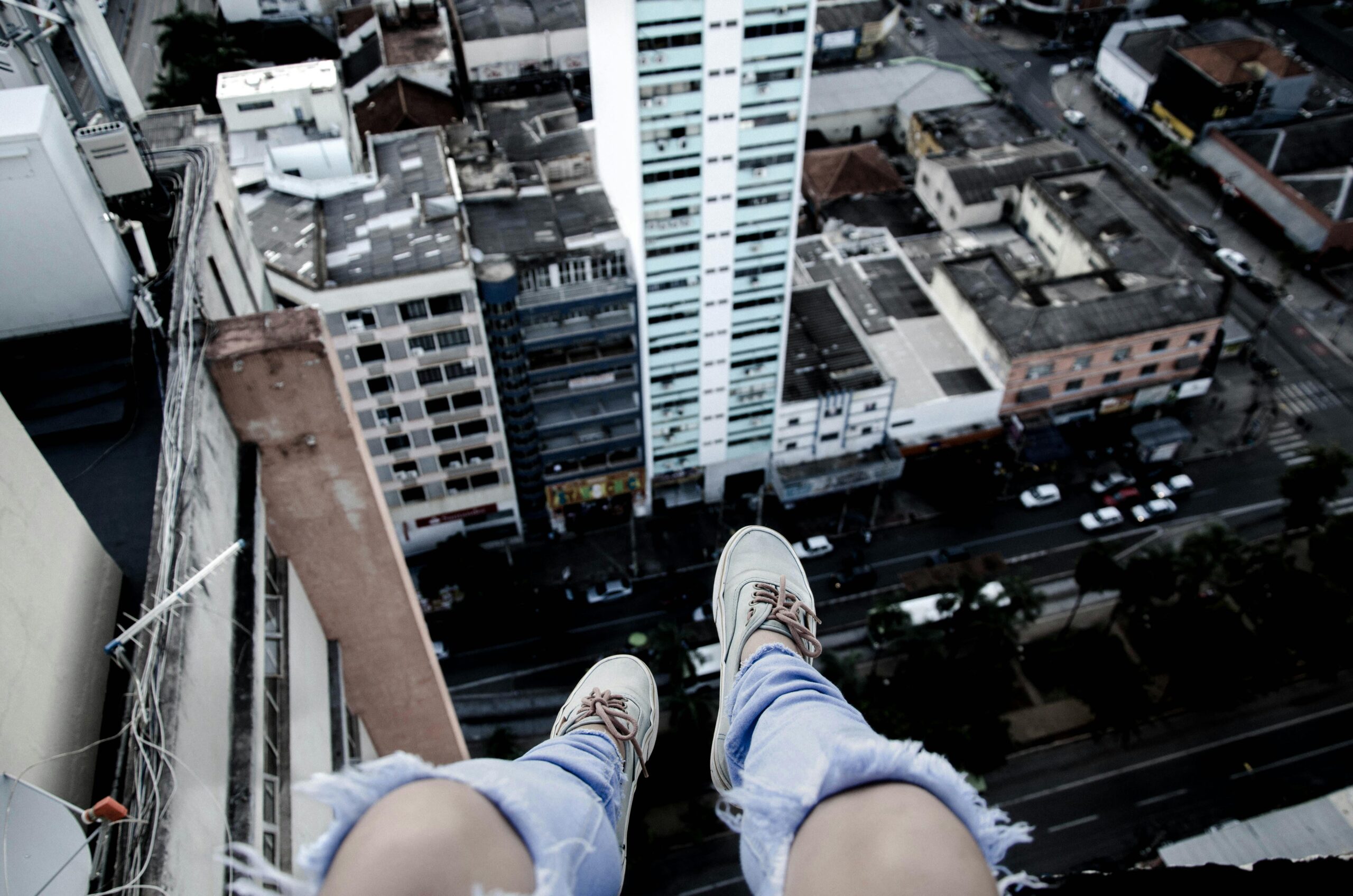 Daring view of a cityscape from above, showcasing sneakers over the city.