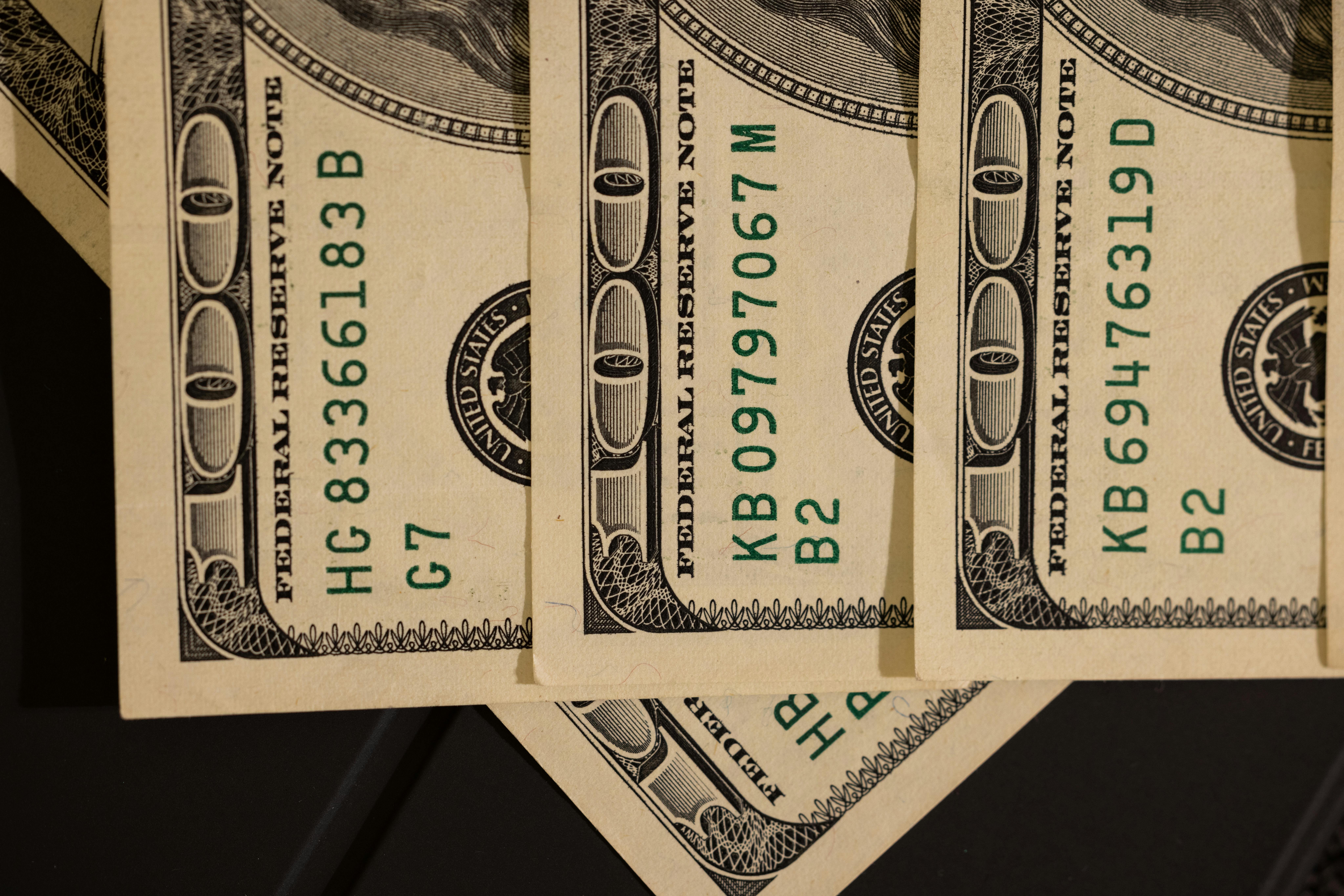 Detailed close-up shot of US dollar bills displaying serial numbers and Federal Reserve details.