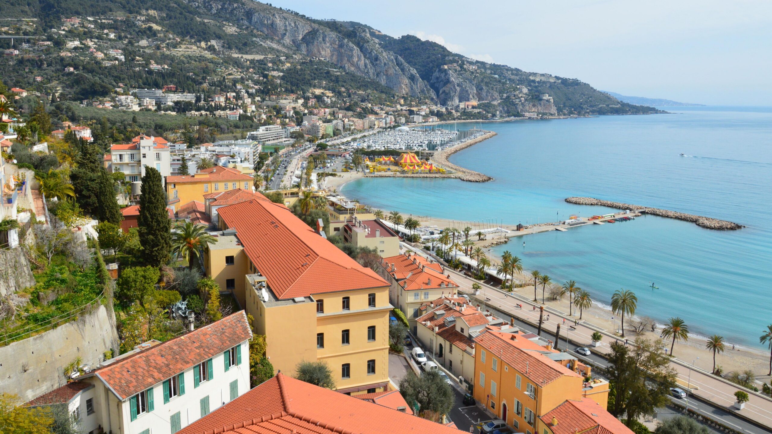 Stunning aerial view of a Mediterranean town along a pristine coastline with azure waters.