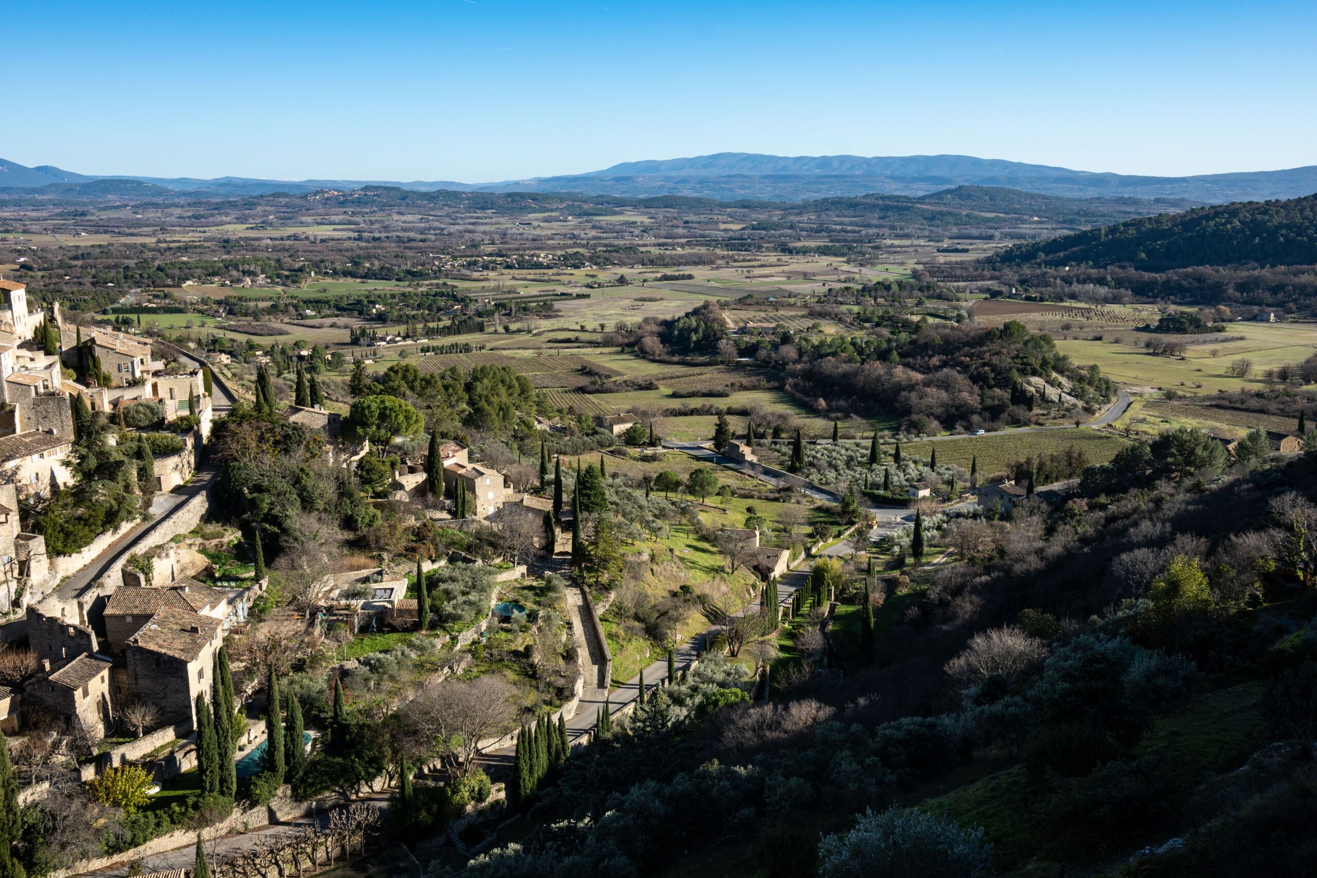 Aerial view of Gordes, a beautiful village in Provence, France with lush landscapes and historic architecture.