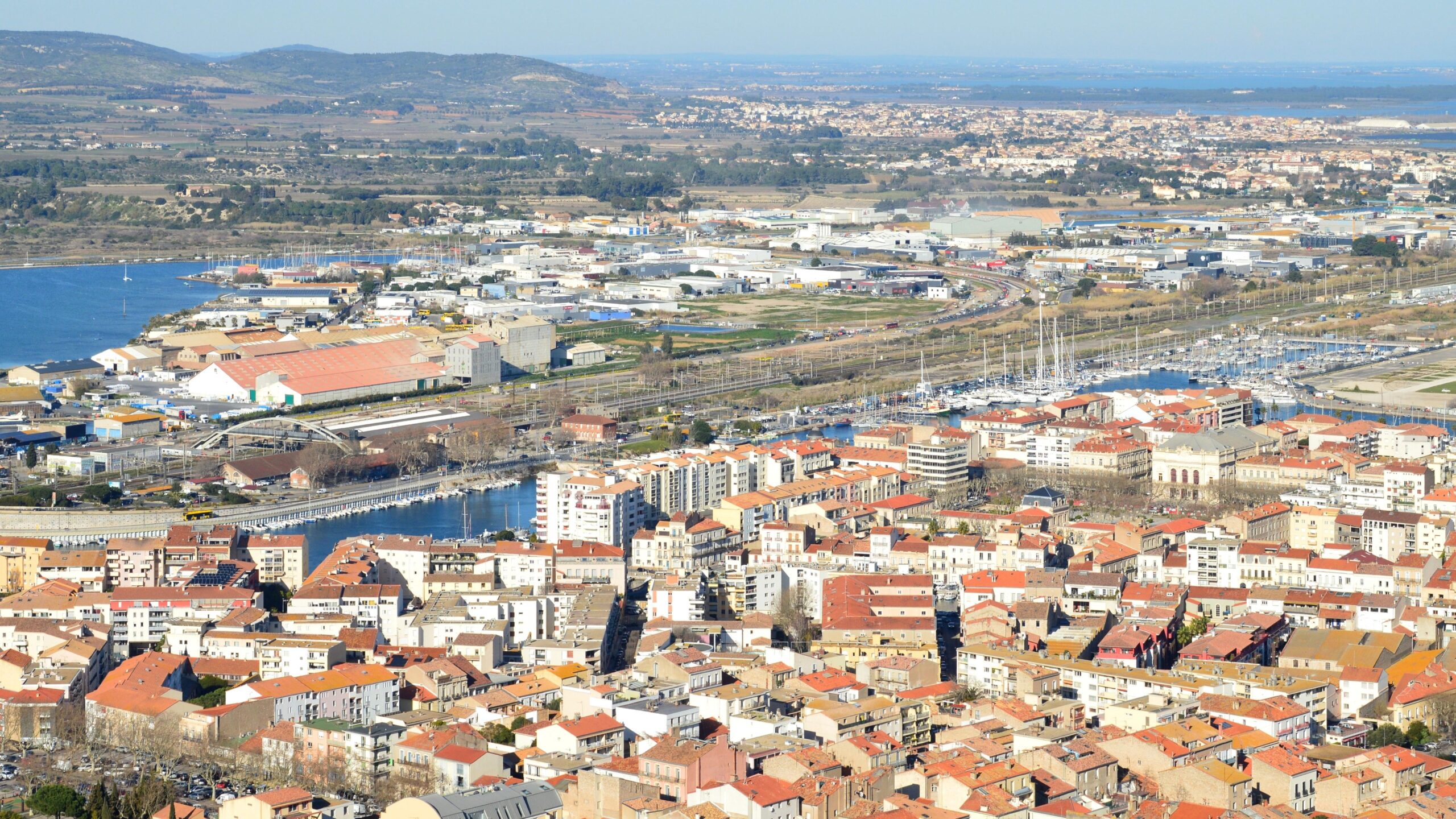 Discover the charming coastal cityscape of Sète, Occitanie, from above.