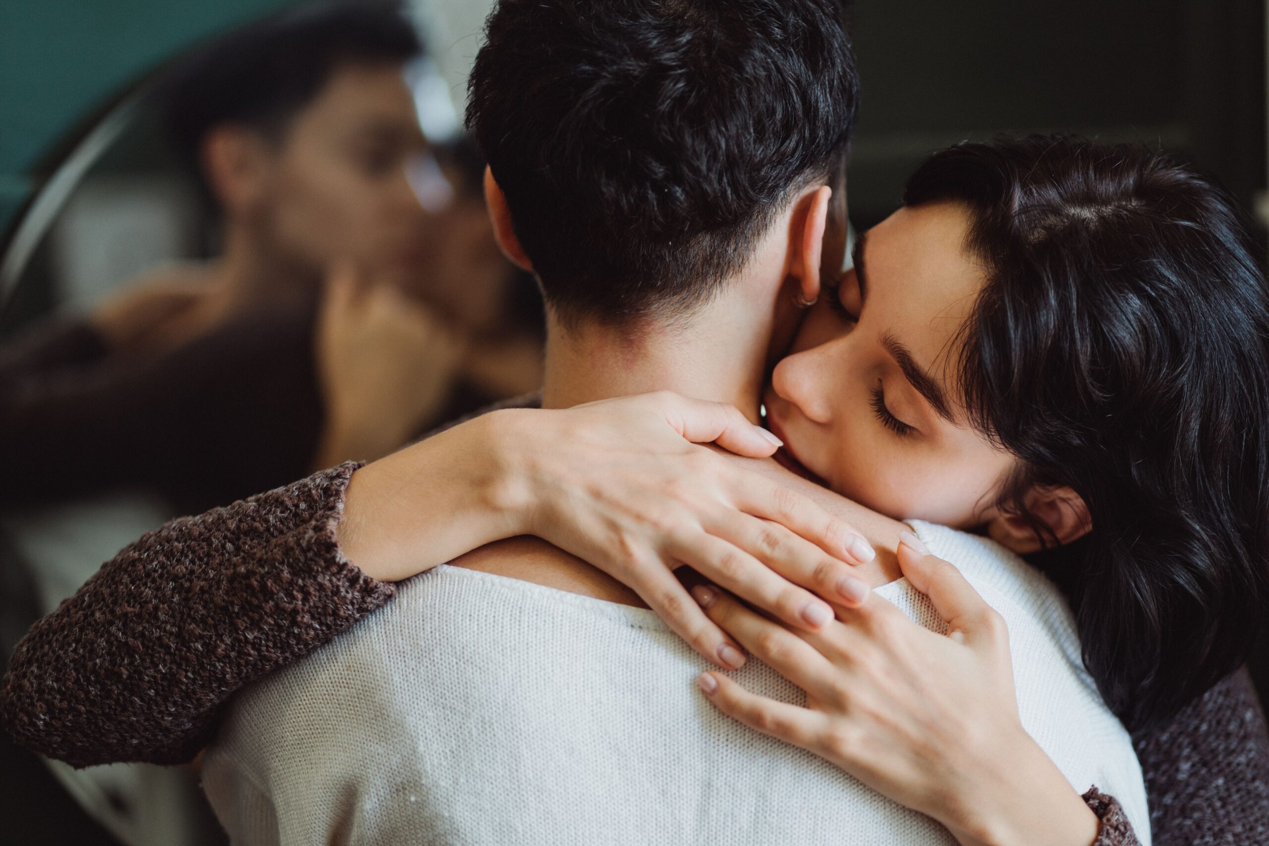 A close-up of an intimate embrace, showcasing love and connection indoors.
